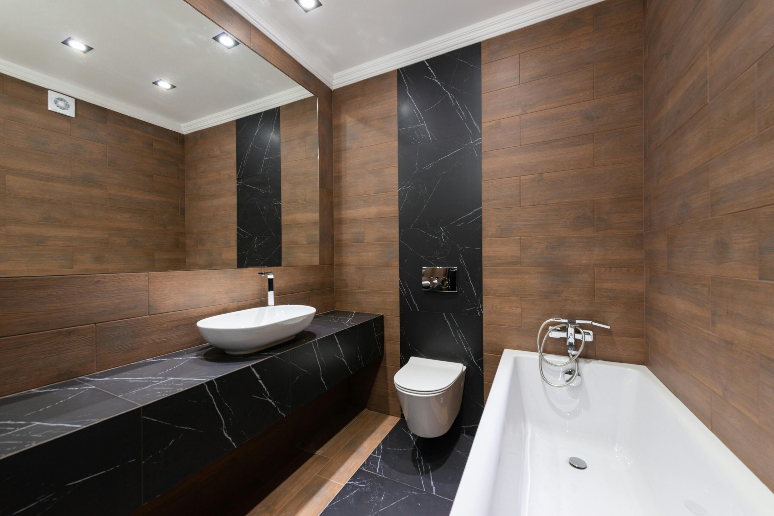 Modern bathroom with wooden accents, sleek fixtures, and minimalist design.